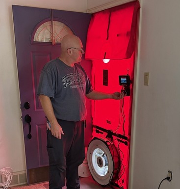 Energy Auditor running a Blower Door Test