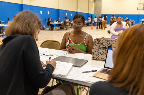 Staff assists woman at clinic