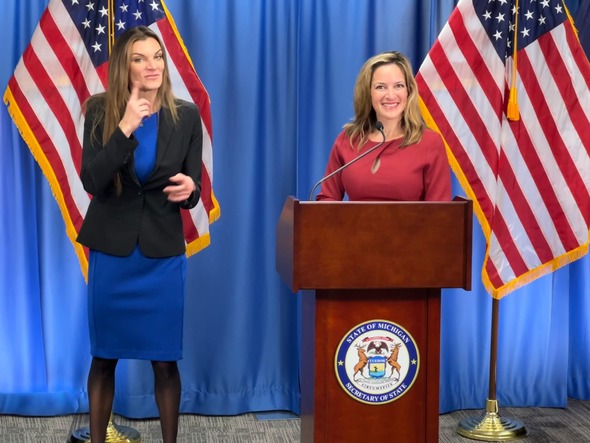 ASL interpreter and Secretary Benson at early voting pilot press conference  