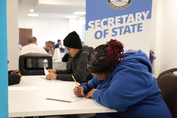 Participants fill out paperwork at Road to Restoration Clinic in Saginaw