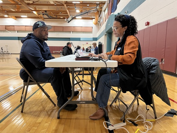 Participant fills out paperwork at Road to Restoration clinic in Monroe