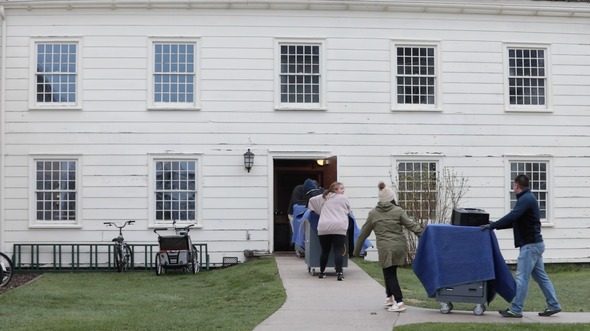 Michigan Department of State staff haul mobile office equipment to the Mackinac Island Community Hall for set up. 