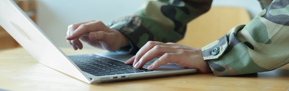 Military member on computer