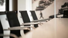 Empty boardroom table with chairs