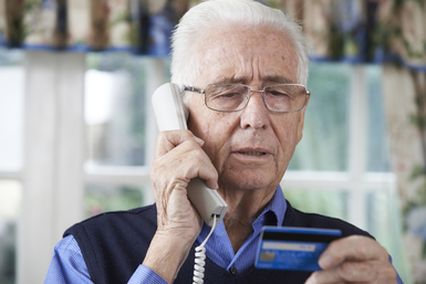 Senior man giving Credit Card. (c) Bigstock.