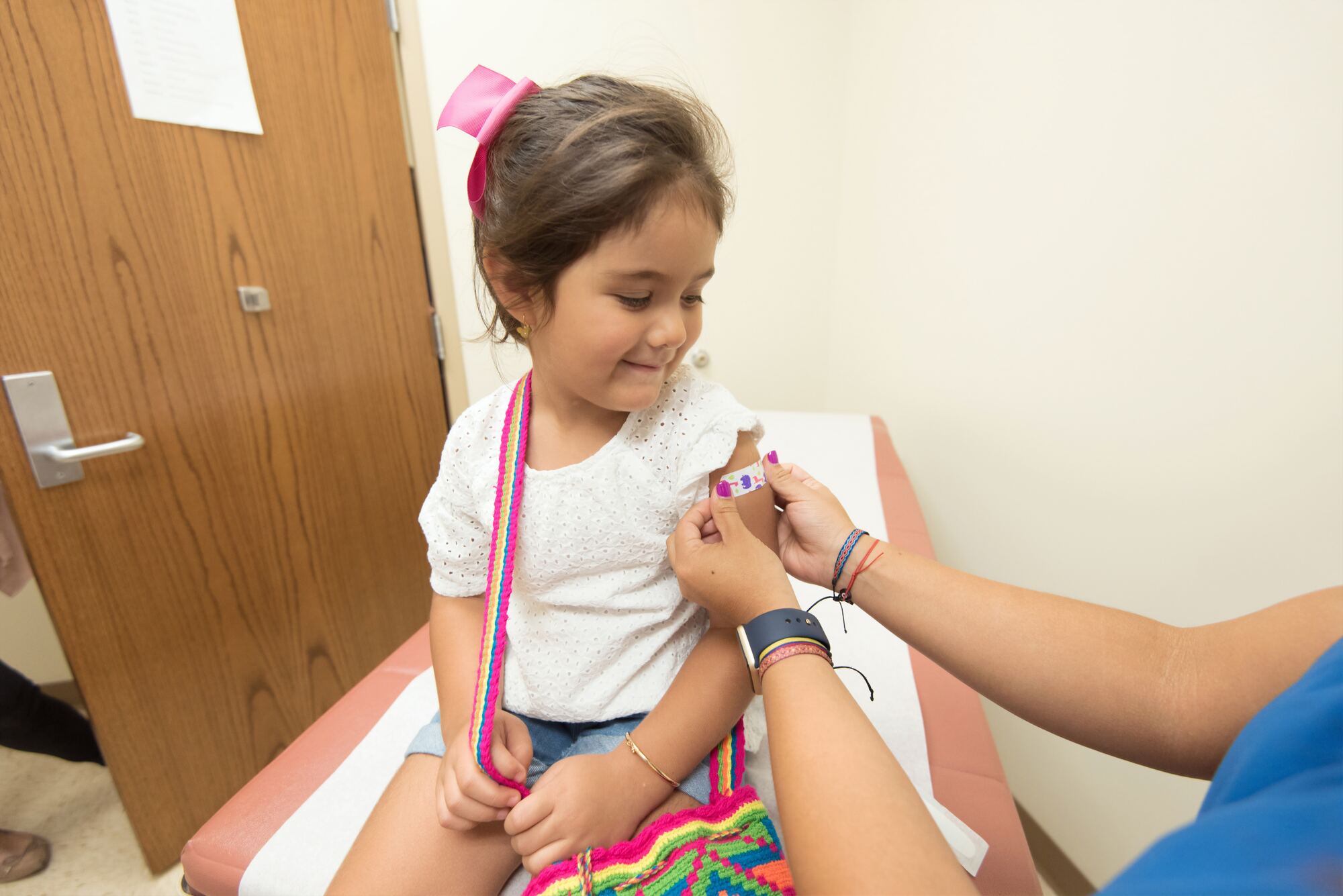 Smiling child with band-aid after flu shot