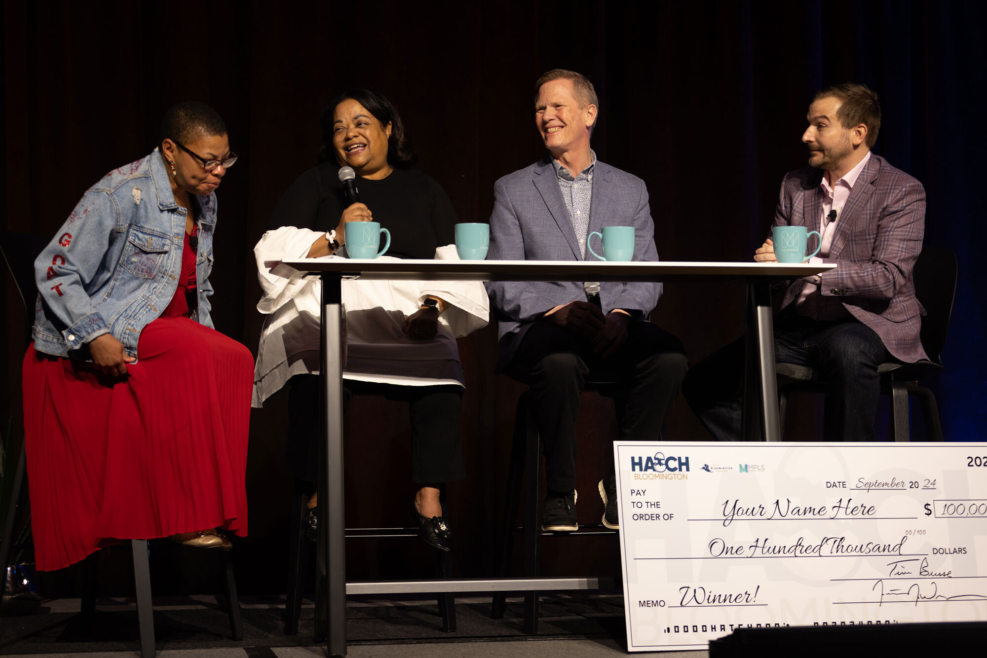 Hatch Bloomington announcment with big check for $100,000.