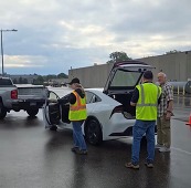 Workers unloading supplies from a car