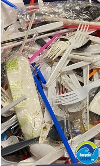 Plastic pieces and plastic silverware in a pile 