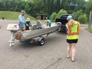 Inspector approaching a boat with a young family getting ready to launch 