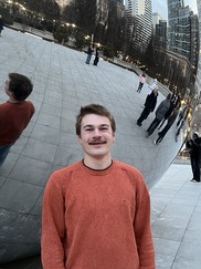 Photo of male person with a lake in the background