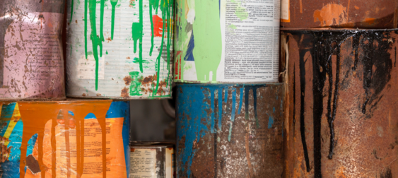 Cans of paint with paint spilled on them