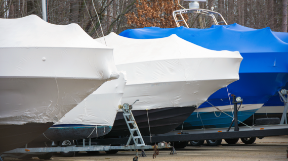 Plastic film stretched over boats 