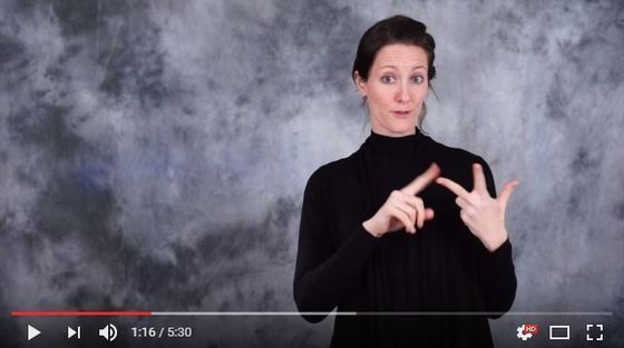 Still frame from the January 30 Legislative Update ASL video. Misty Schomberg is signing, "third."