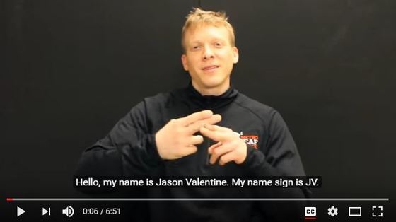 Still image of Commission Chair Jason Valentine. He is signing, "name." 