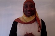 Valerie Shirley, she is wearing a black and white top and a red and yellow striped hijab.