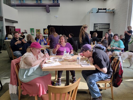 folks at deafblind town hall eating pizza