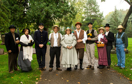 Group of actors dressed as historical people in cemetery