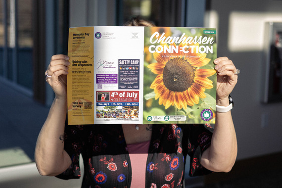 Summer 2026 Connection being held open by a women with cover pages blocking her face
