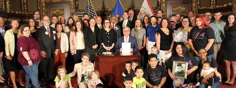 Group of people with Governor Walz at the Rare Disease Advisory Council signing