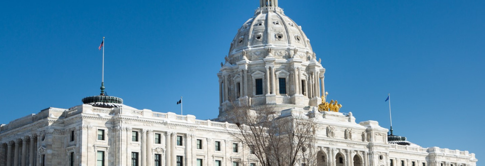 Minnesota State Capitol building with a bright blue sky in the background.