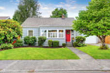 small grey house with a red door