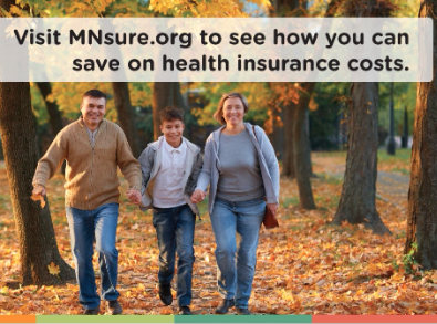 photo of a family walking through the fall leaves