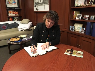 Justice McKeig signs the roll book
