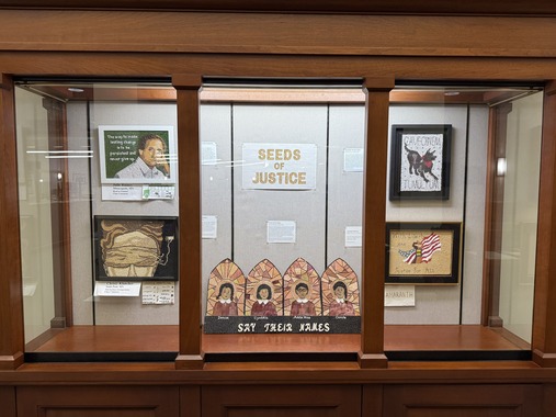 Image of a display case containing several pieces of crop art. 