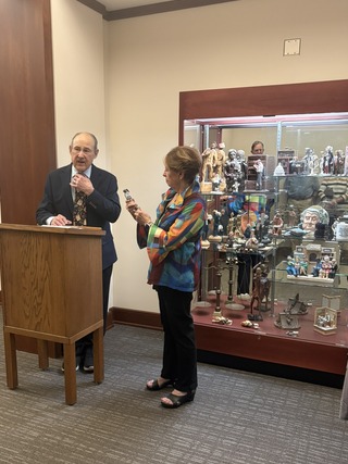 Image of Attorney Steve Gordon and his wife in front of a glass display case featuring the Steve Gordon Collection