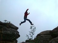 Person leaping across chasm