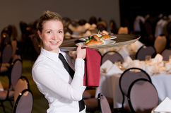 Waitress carrying a tray of food
