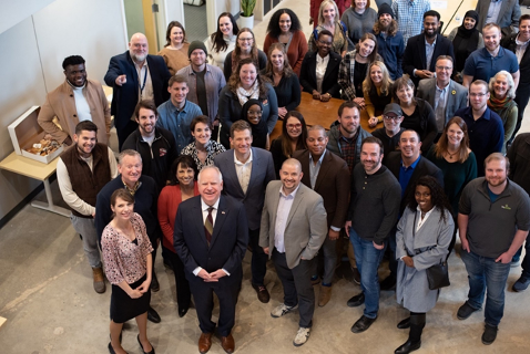 Governor Walz standing with a crowd of entrepreneurs in St. Cound