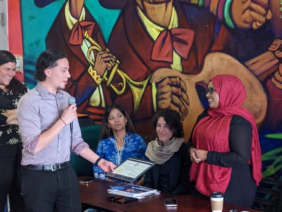 Anisa receives a certificate at Mercado Central in Minneapolis.