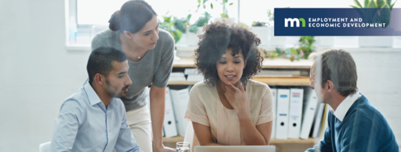 Group of people looking at laptop