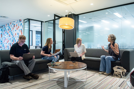 Four people sitting around a table having a discussion