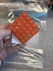 A close-up image of bump dots, which you stick onto frequently used objects for both identification and directional orientation. 