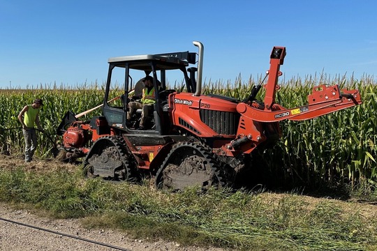 Work crew in Waseca County plowing fiber in the ground.
