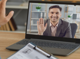 Man on computer screen waving