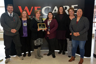 DHS Commissioner Emily Piper and six WECARE staff members pose with their 2018 Commissioner's Circle of Excellence award.