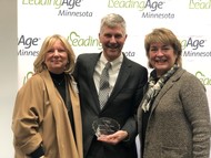 DHS Commissioner Lourey and two members of LeadingAge Minnesota pose with 2019 Public Official of the Year Award