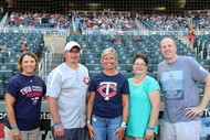 five people on the field at the Twins stadium