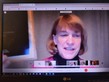Commissioner Harpstead holds up Circle of Excellence plaque during an online meeting with award recipient CHUM in Duluth