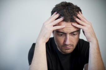 Photo of man looking very sad and tired