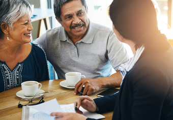 Stock photo of elder couple meeting with advisor