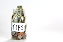 A jar that says, "Tips" with money inside
