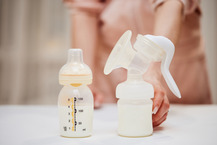 Breast pump and bottle sitting on a table