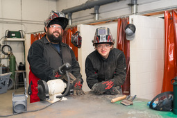 Two welders smiling