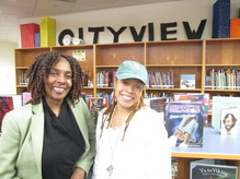 Two women smiling in a school library