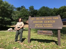 park staff next to fort snelling state park sign